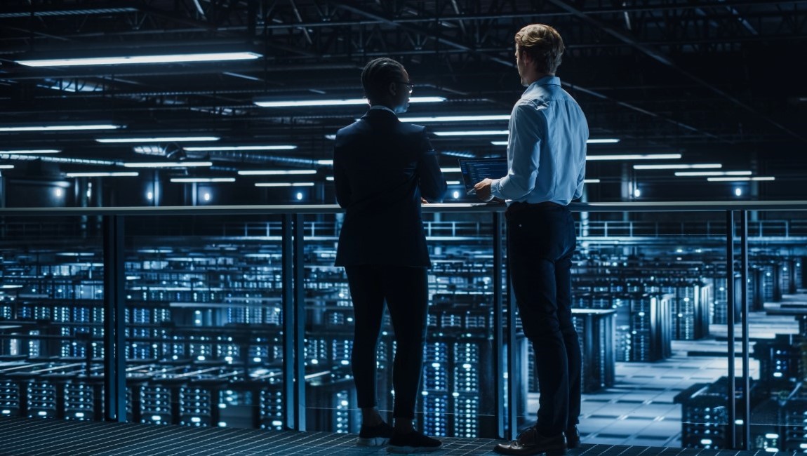 Two network engineers looing over a data center