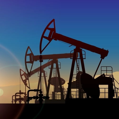 Oil drilling rigs at sunset